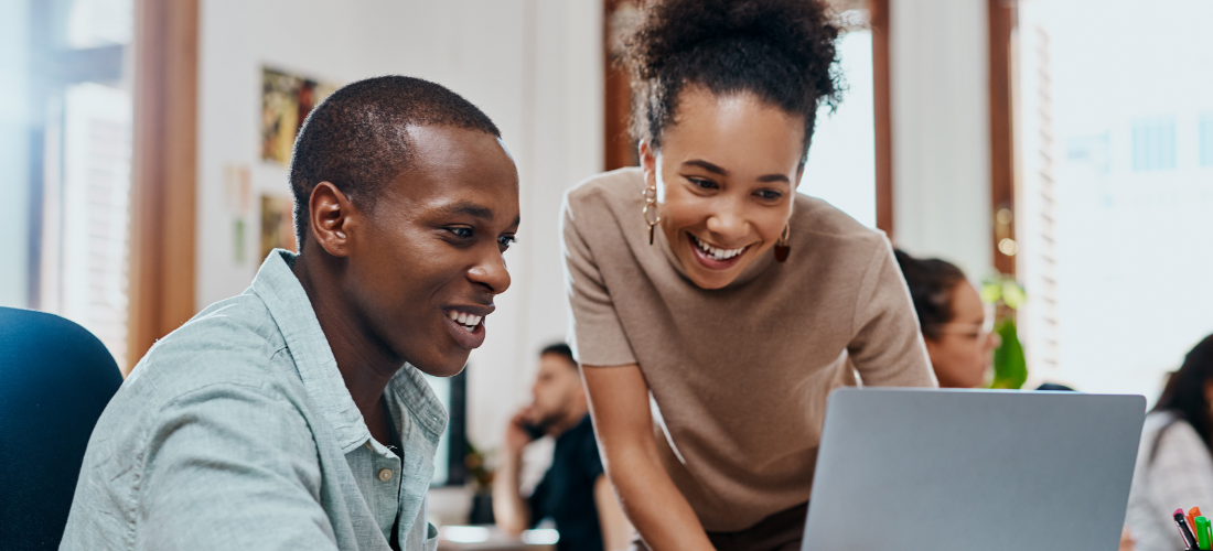 A women and man collaborating on a project on a laptop